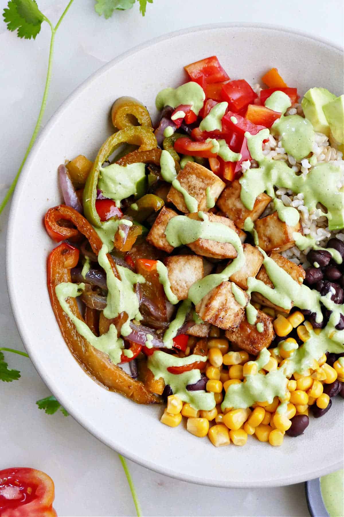 tofu burrito bowl with tahini dressing in a serving dish