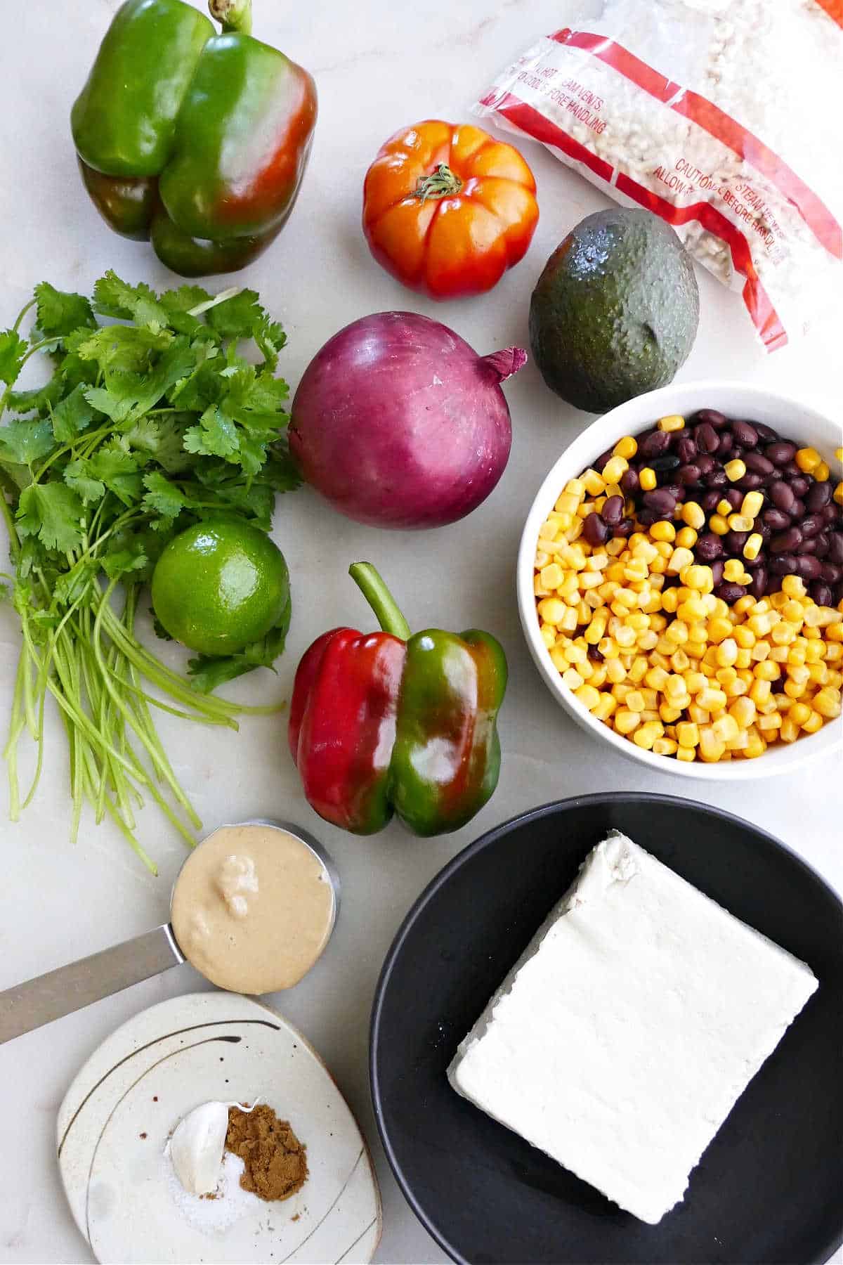 ingredients for tofu burrito bowls next to each other on a counter