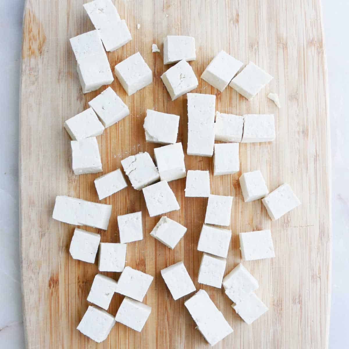 tofu cut into cubes on a cutting board