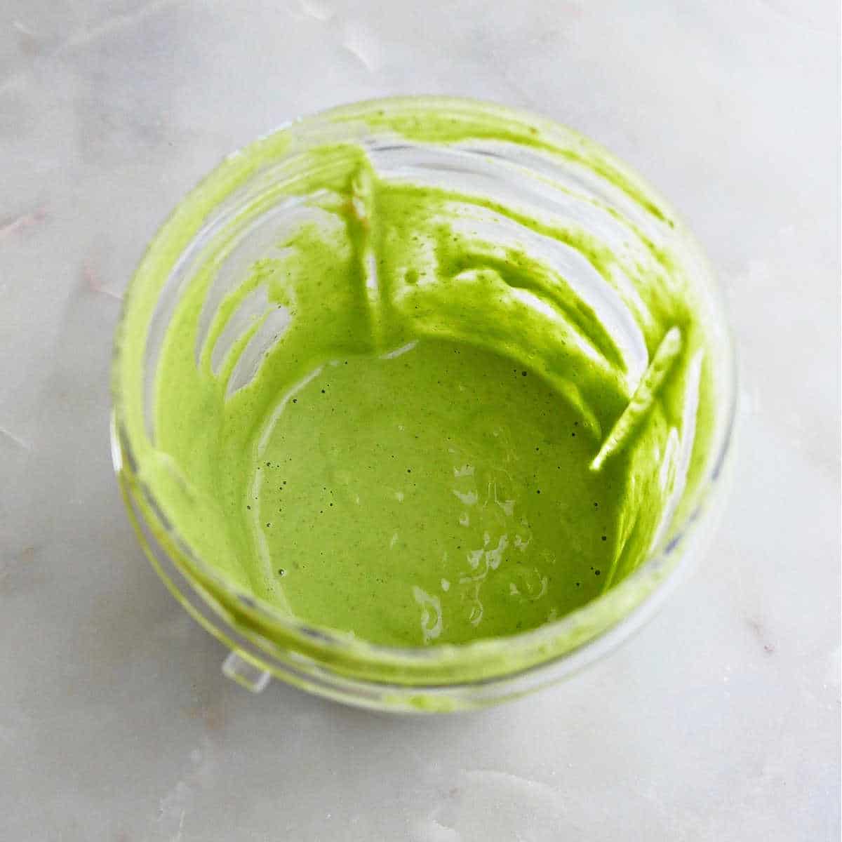 cilantro lime tahini dressing blended together in a cup