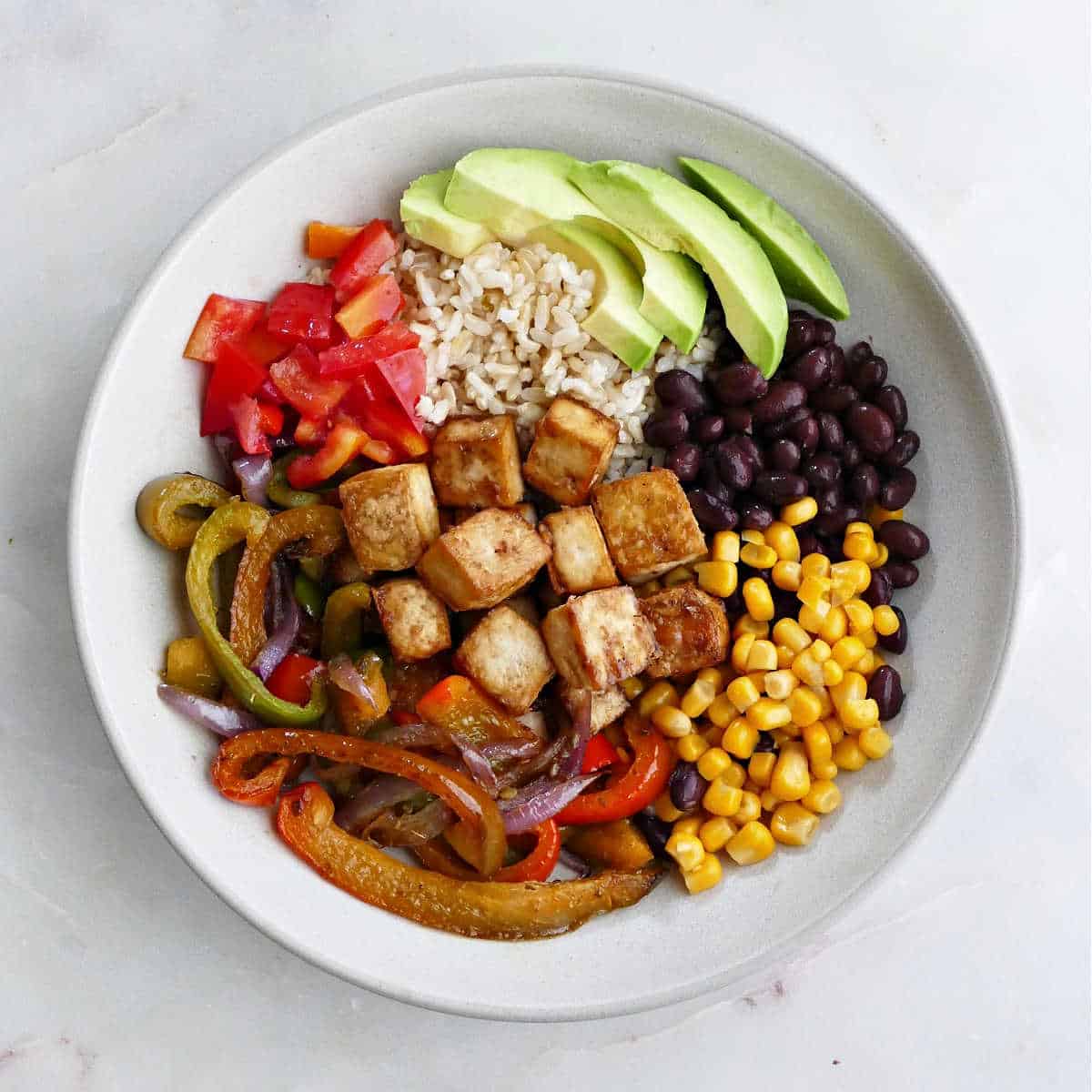 tofu burrito bowl before dressing is added on a counter