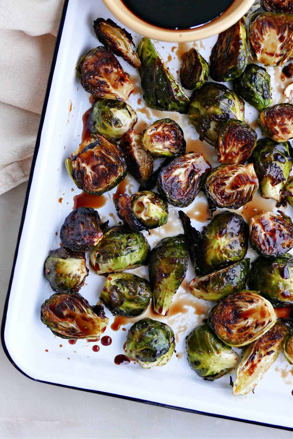 candied brussels sprouts with a maple syrup balsamic glaze on a serving platter