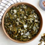 slow cooker collard greens in a serving bowl on a counter