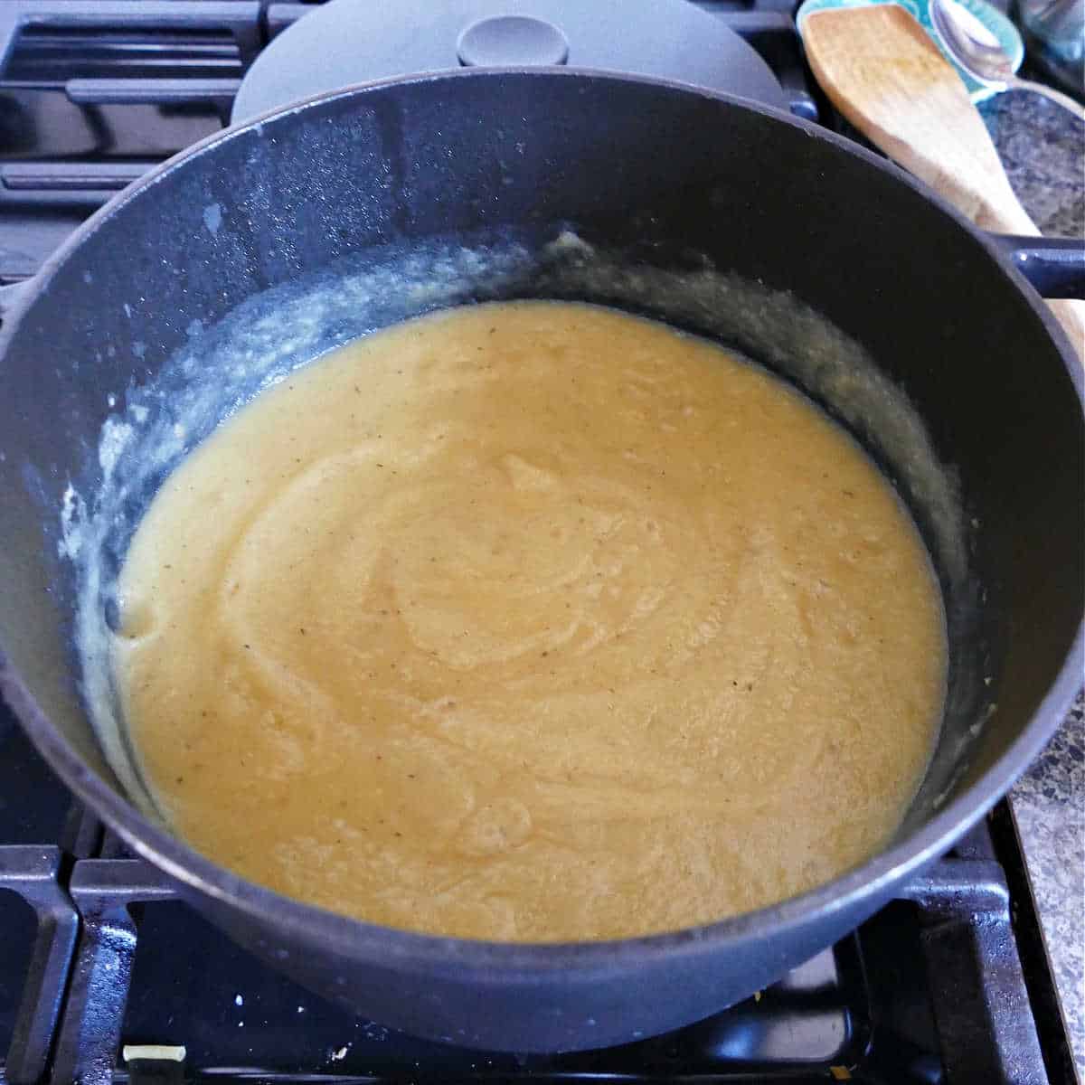 pureed swede and potato soup in a large pot on a stovetop