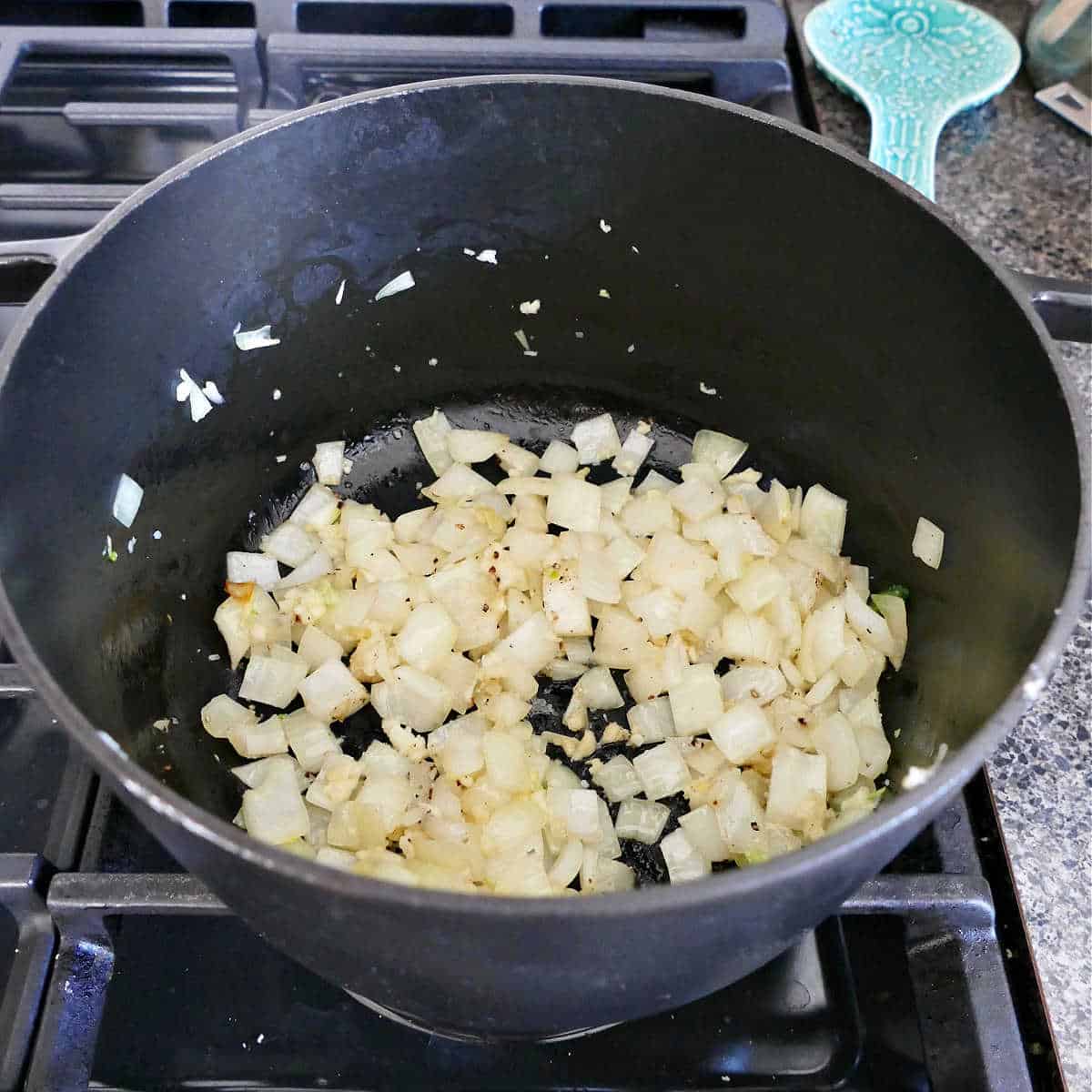 onion and garlic cooking in olive oil in a large soup pot