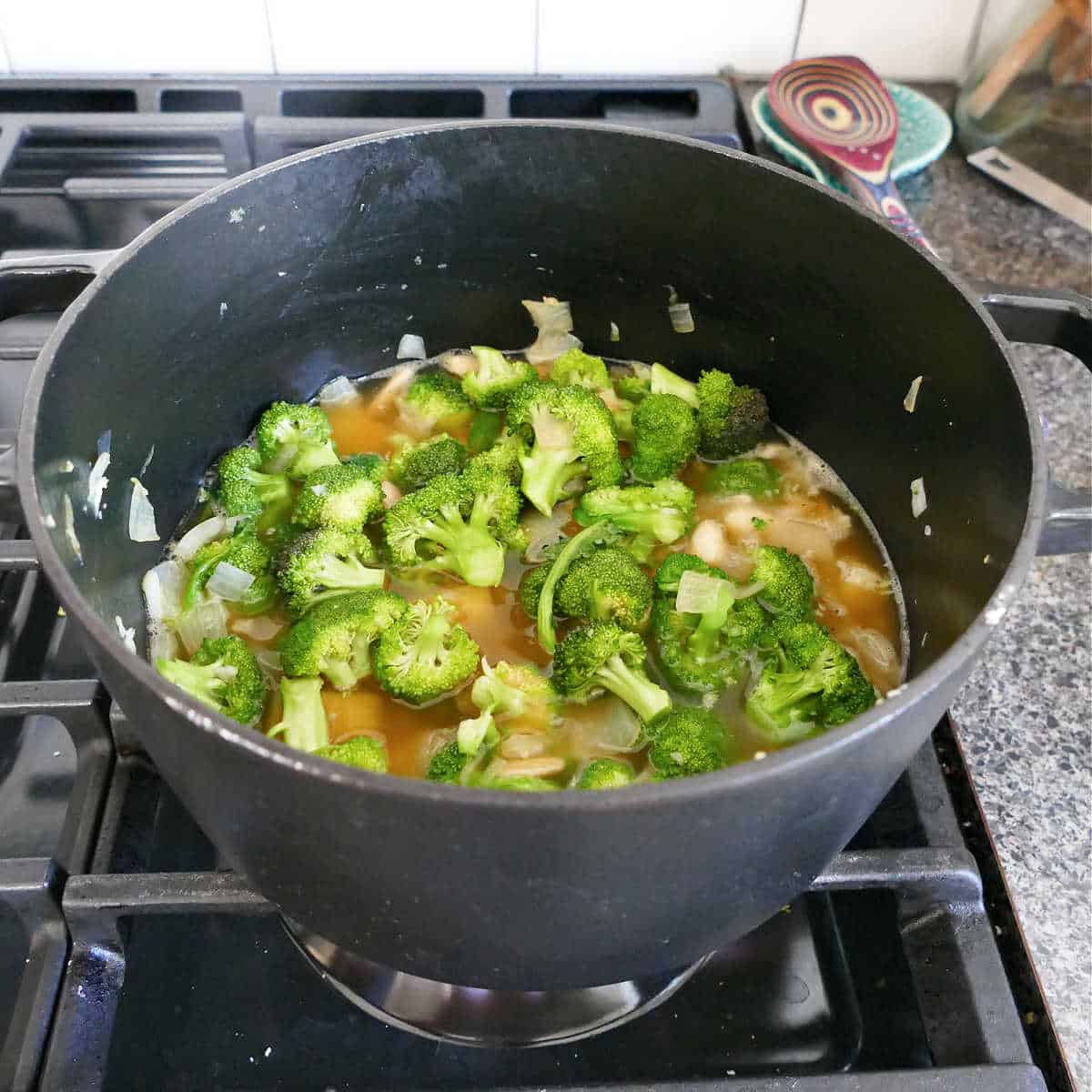 ingredients for broccoli soup cooking in a soup pot