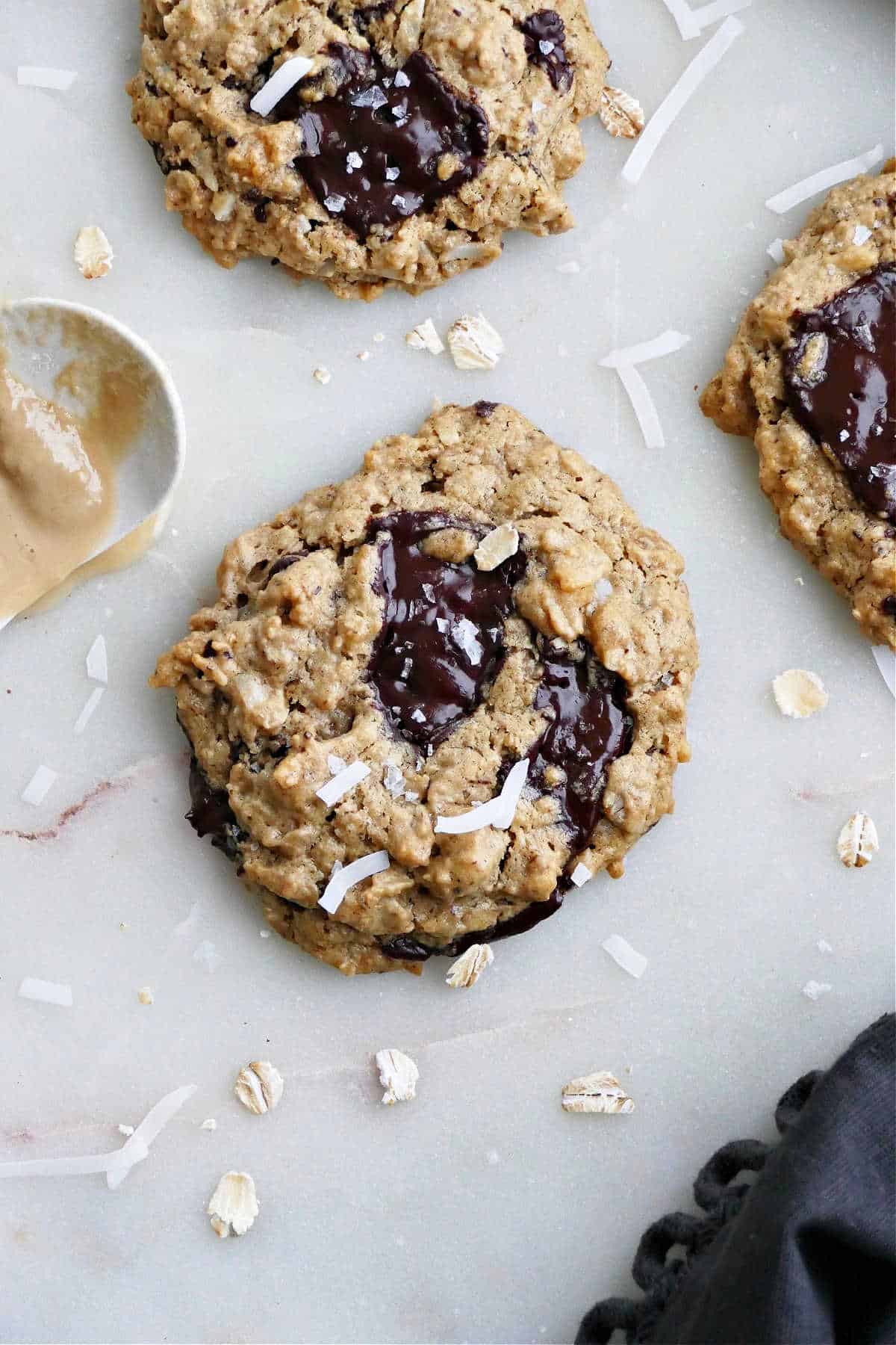 tahini oatmeal cookies with chocolate and coconut on a counter