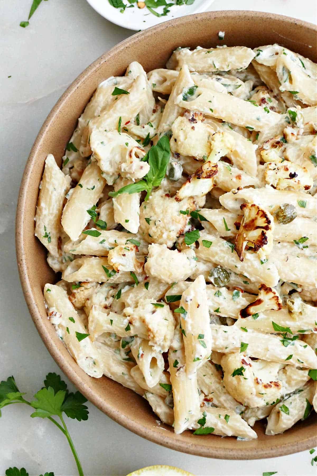 tahini pasta with cauliflower and capers in a serving bowl