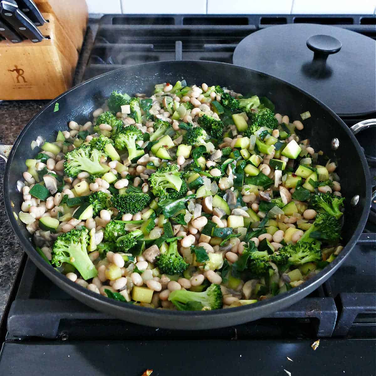 vegetables for lasagna cooking in a large skillet over a stove