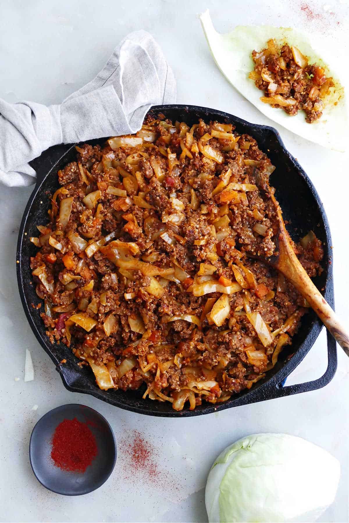 deconstructed cabbage roll in a skillet surrounded by ingredients