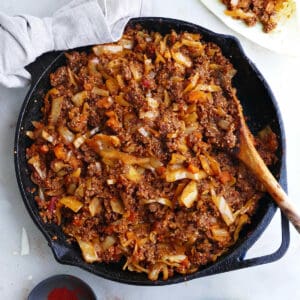 deconstructed cabbage roll in a skillet with a spoon on a counter