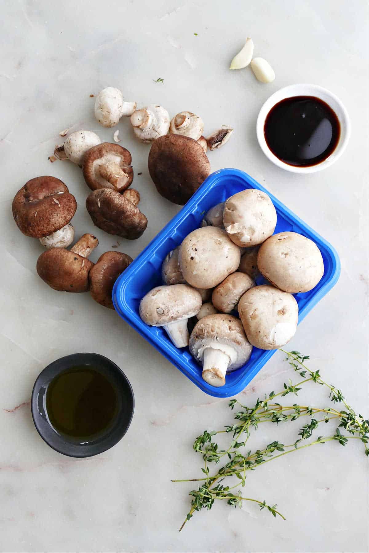 mushrooms, maple syrup, thyme, balsamic vinegar, and garlic on a counter