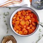 microwave carrots in a serving bowl surrounded by toppings