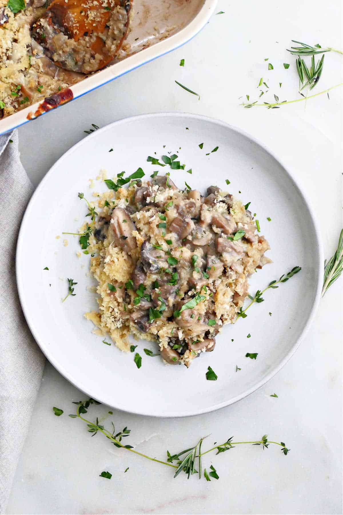 serving of mushroom au gratin on a plate with thyme