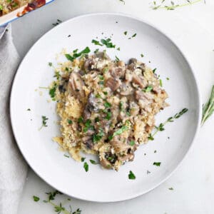 serving of mushroom au gratin on a plate with thyme