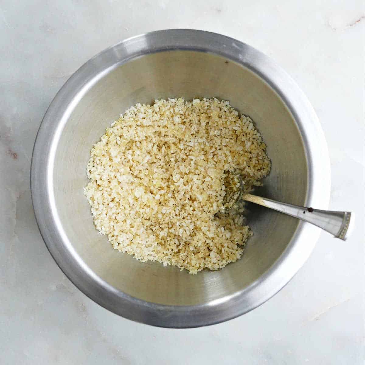 bread crumbs mixed with olive oil in a bowl