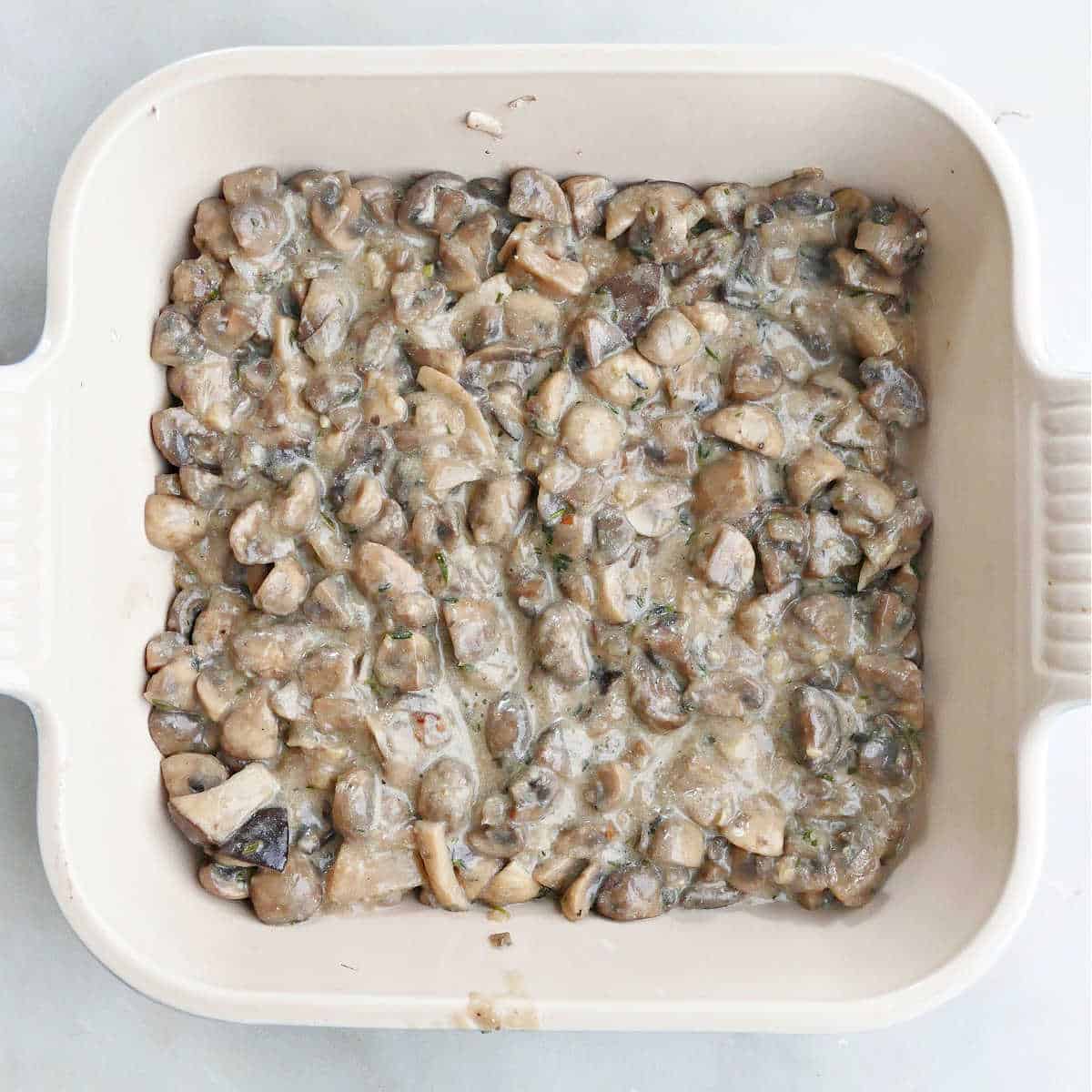 mushroom gratin filling in a square baking dish