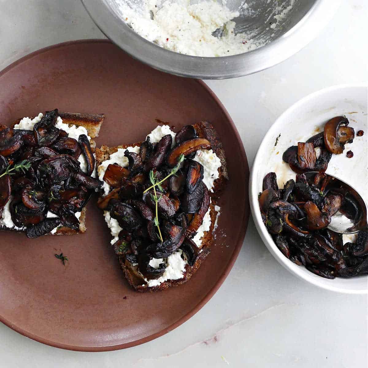 mushroom toast being assembled on a counter