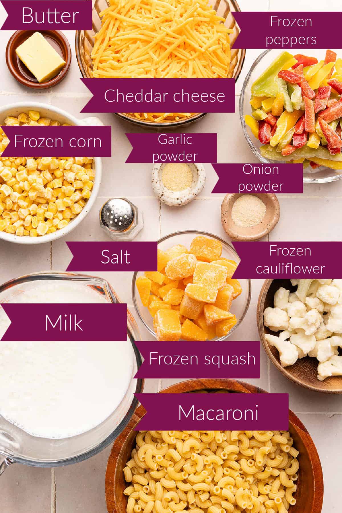 Butter, cheese, peppers, corn, garlic powder, onion powder, milk, squash, cauliflower, and macaroni with labels.