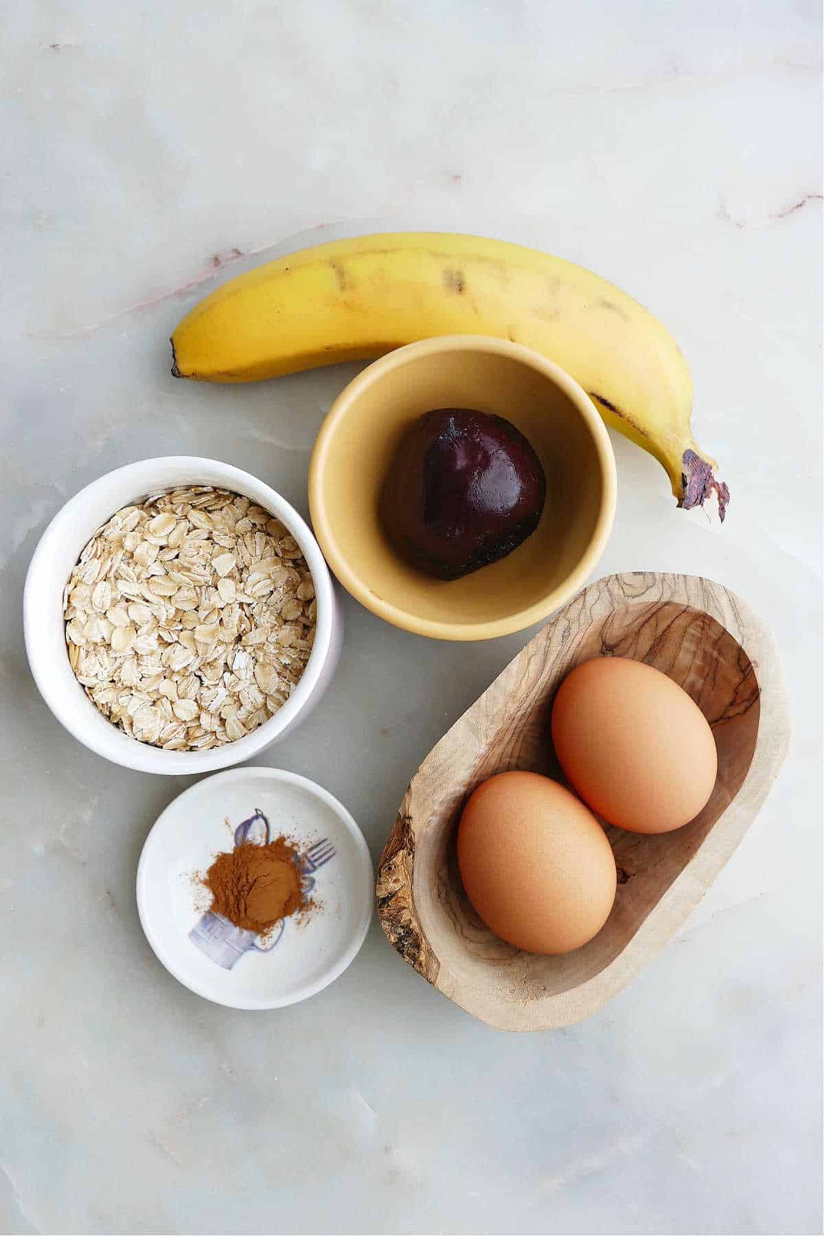 banana, roasted beets, oats, cinnamon, and eggs on a counter