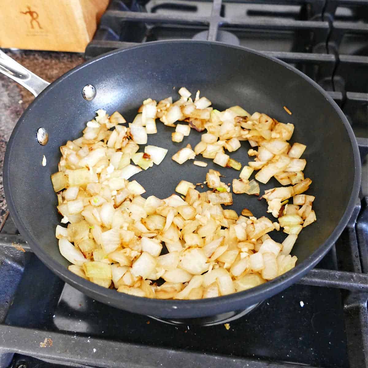 onions and garlic cooking in oil in a skillet