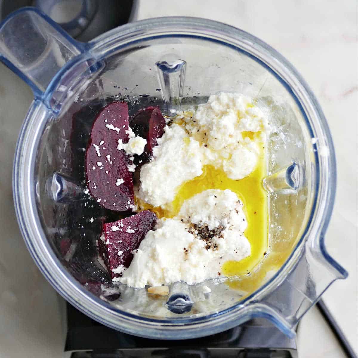 ingredients for beet pasta sauce in a blender before being blended