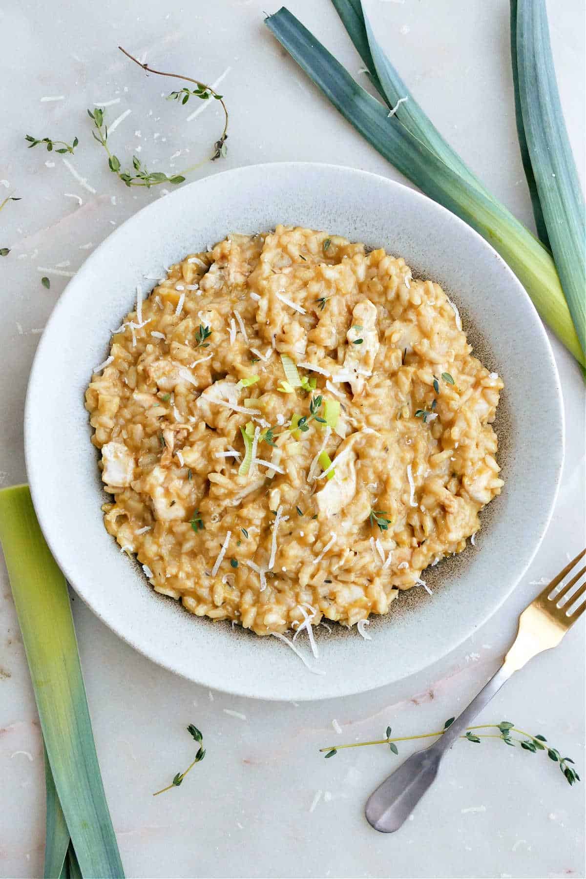 chicken and leek risotto in a serving bowl on a counter