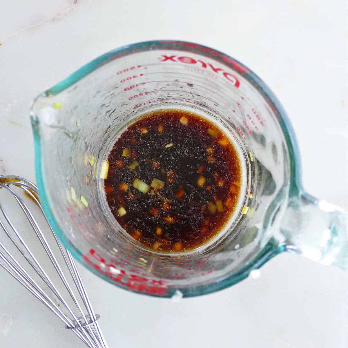sesame soy dipping sauce whisked in a glass measuring cup