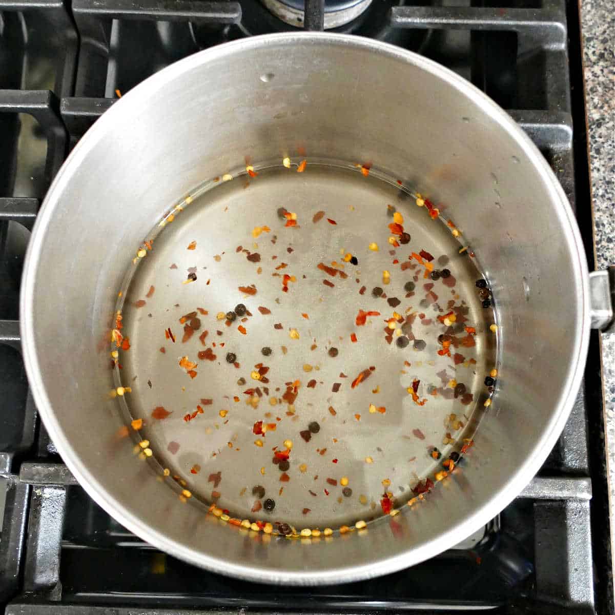 brine made from vinegar, water, salt, sugar, and spices in a saucepan