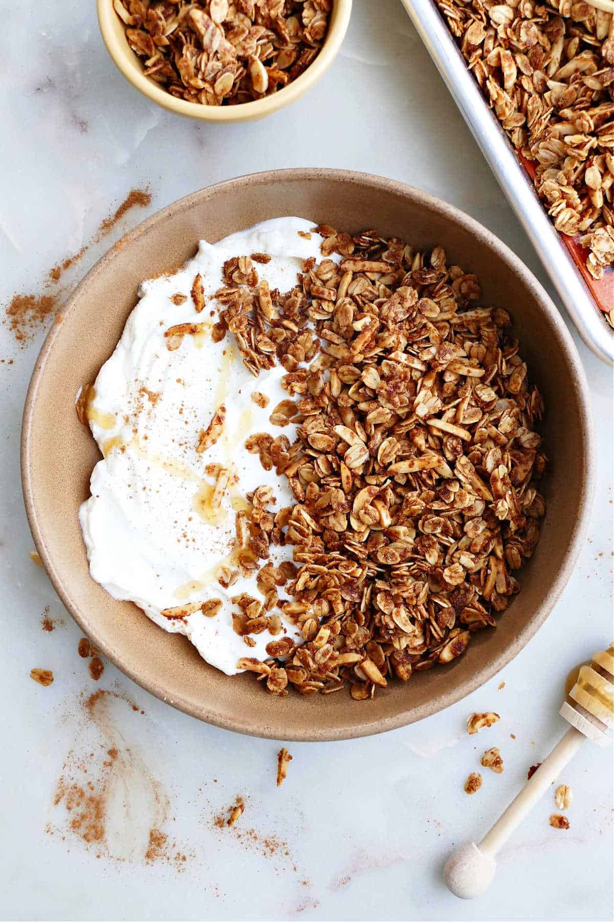 almond and honey granola in a serving bowl with plain Greek yogurt