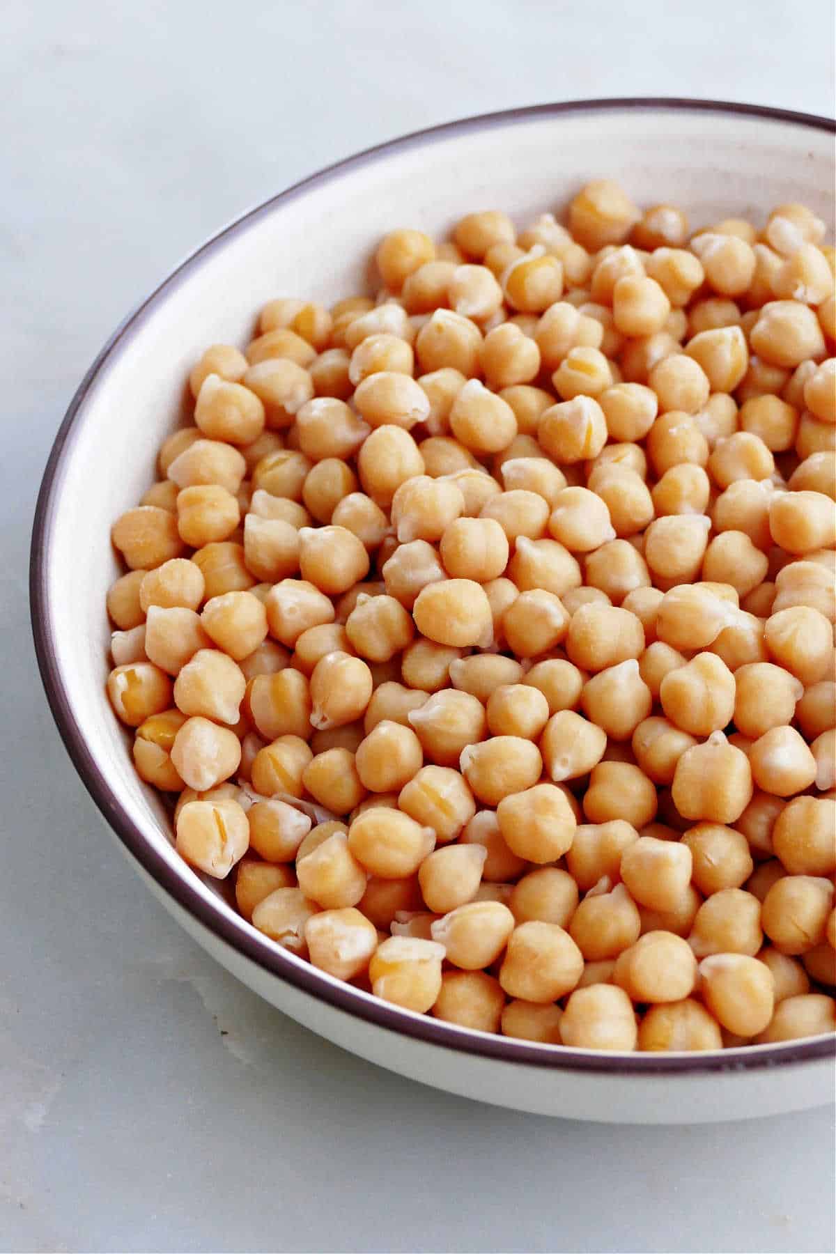 chickpeas cooked on a stovetop in a serving bowl on a counter