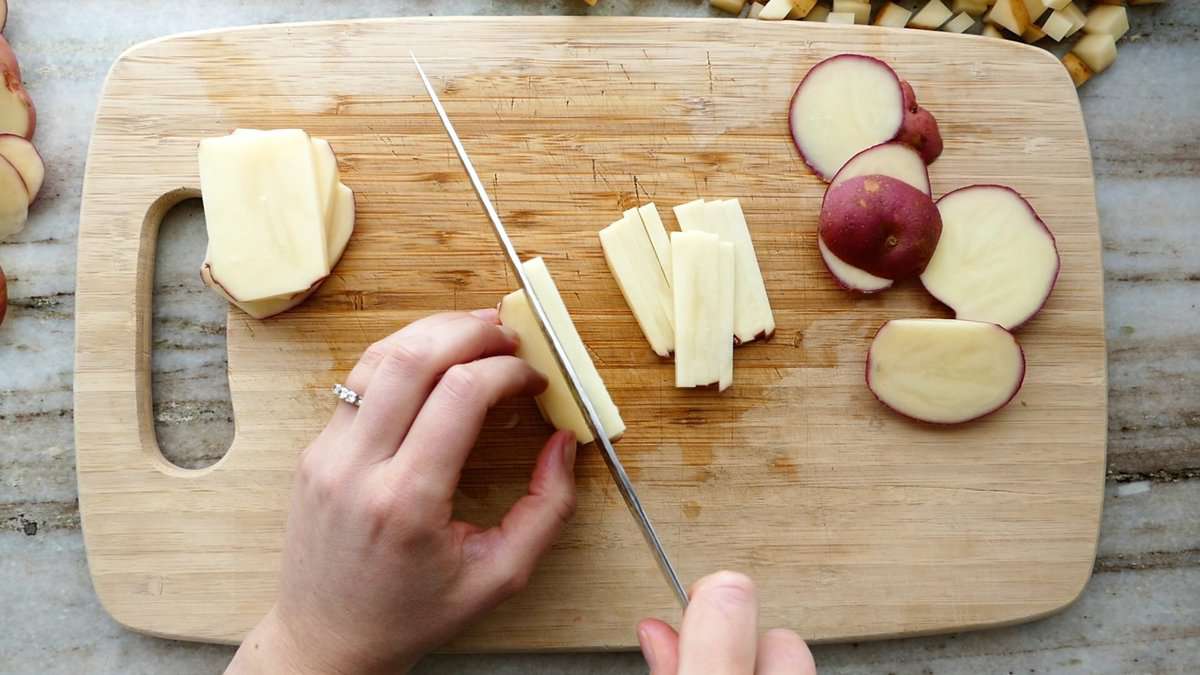 woman performing step three of cutting a potato into julienne pieces