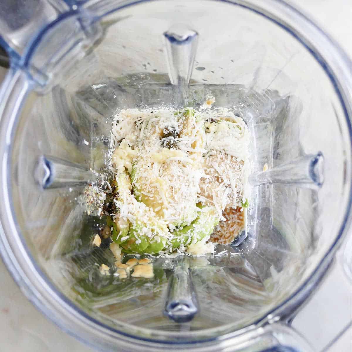 ingredients for avocado Caesar dressing in a high-powered blender before blending