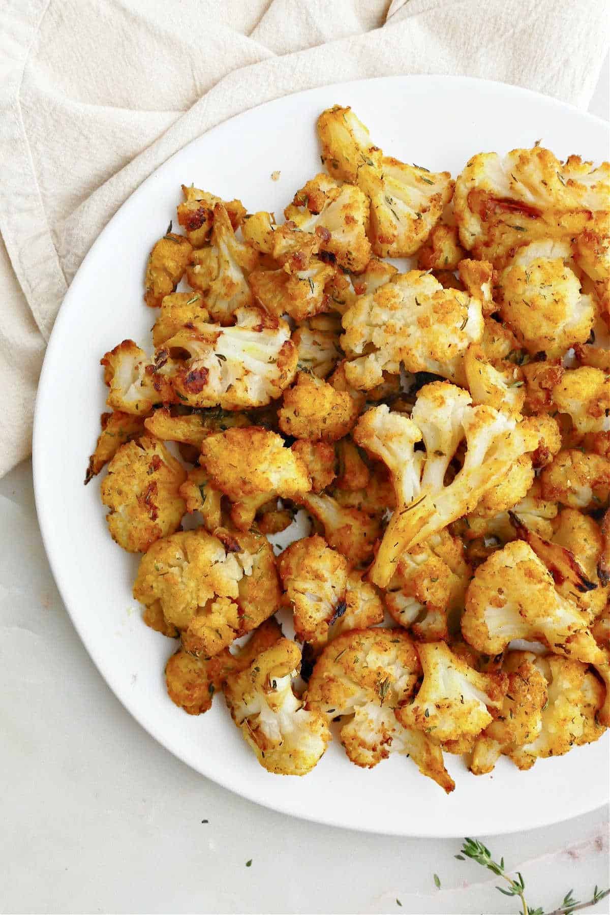 roasted cauliflower on a serving plate on top of a napkin