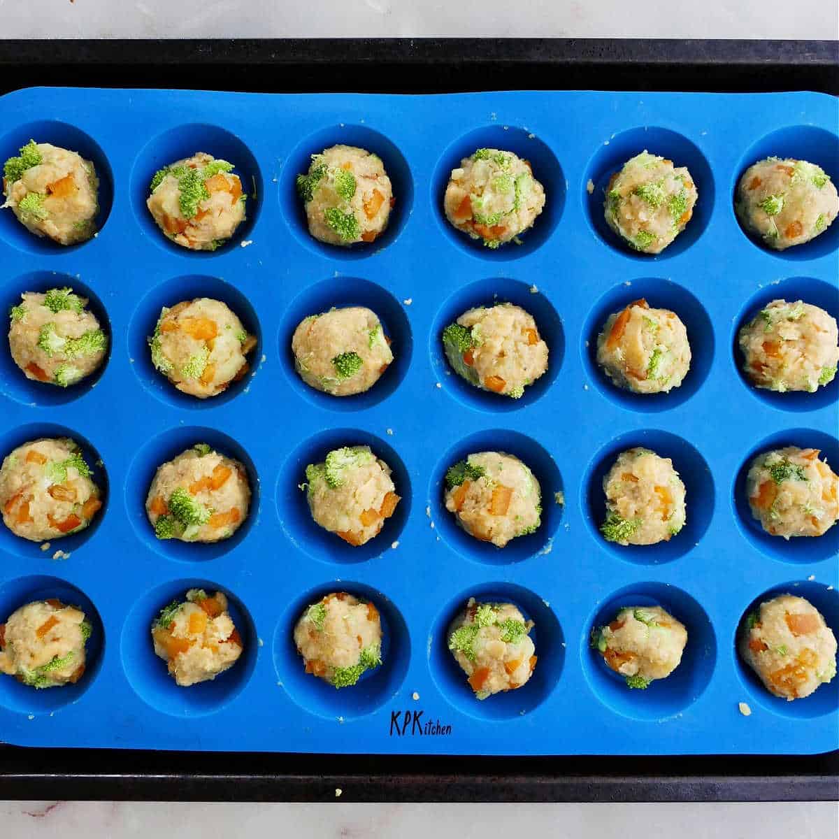 vegetable bites in a mini cupcake pan before being baked in the oven