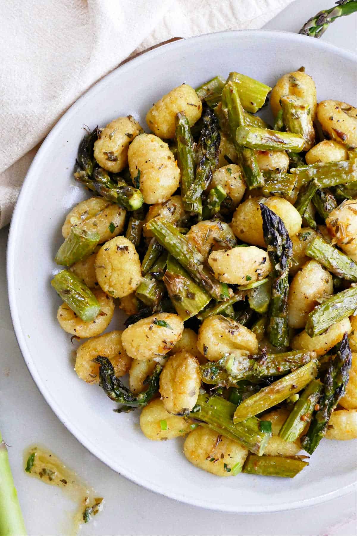 gnocchi and asparagus meal topped with Meyer lemon dressing on a plate