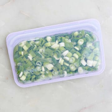 frozen green onions in a silicone freezer bag on a counter
