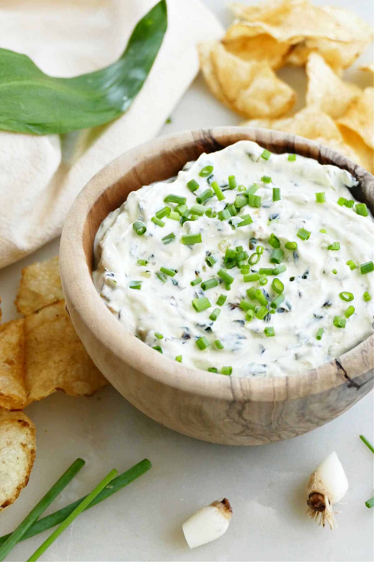 ramp and yogurt dip in a bowl surrounded by ingredients on a counter