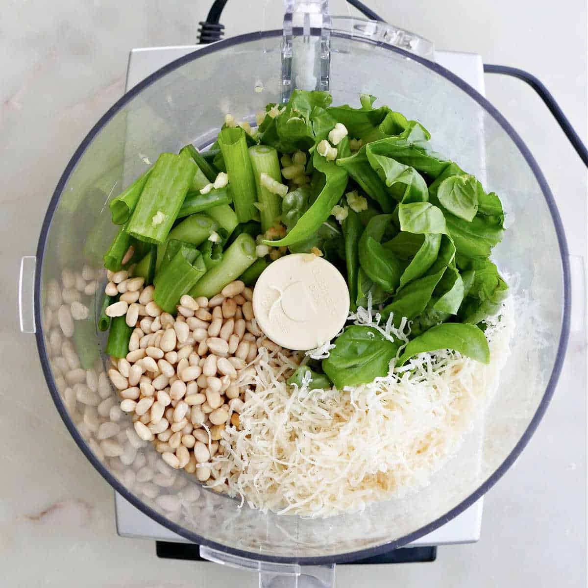 ingredients for scallion pesto in a food processor before being blended