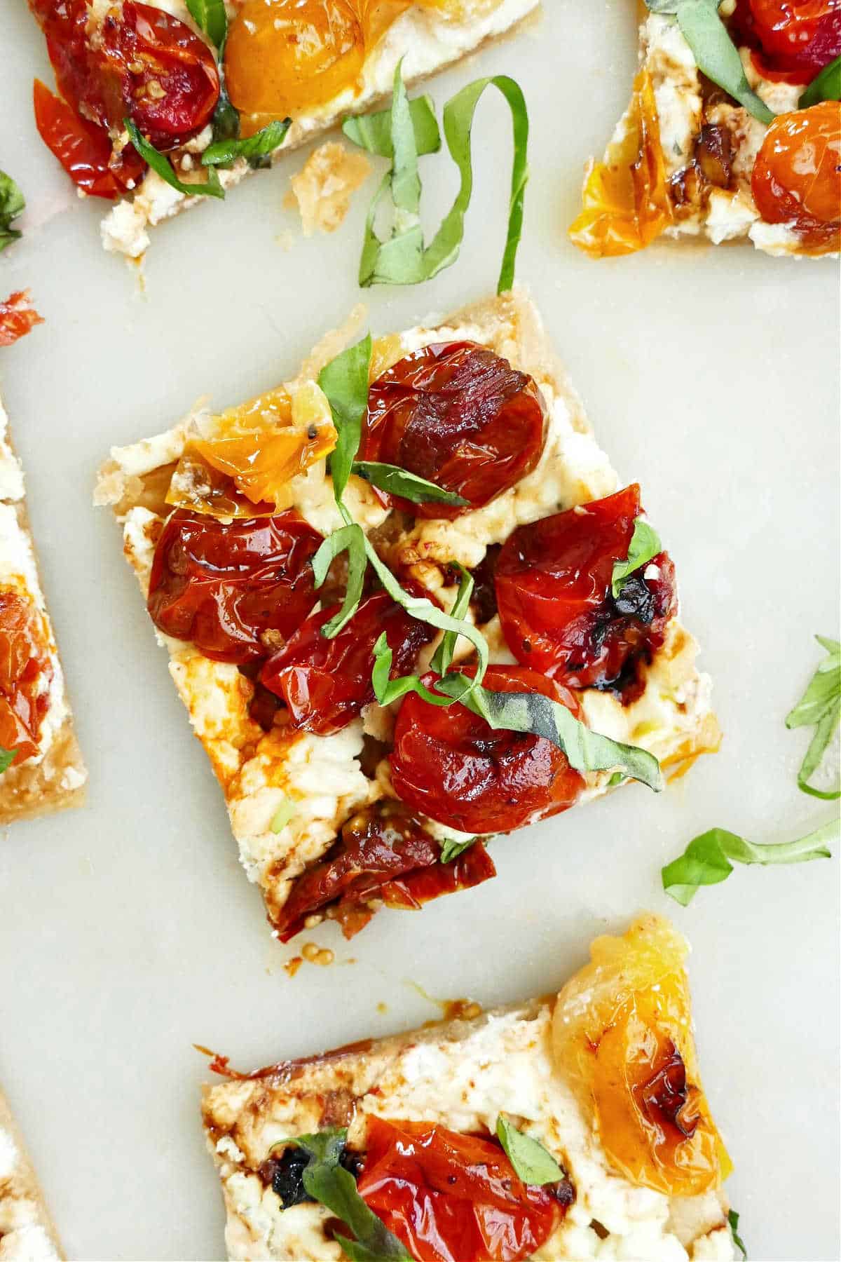 cherry tomato, basil, and boursin cheese on puff pastry on a counter