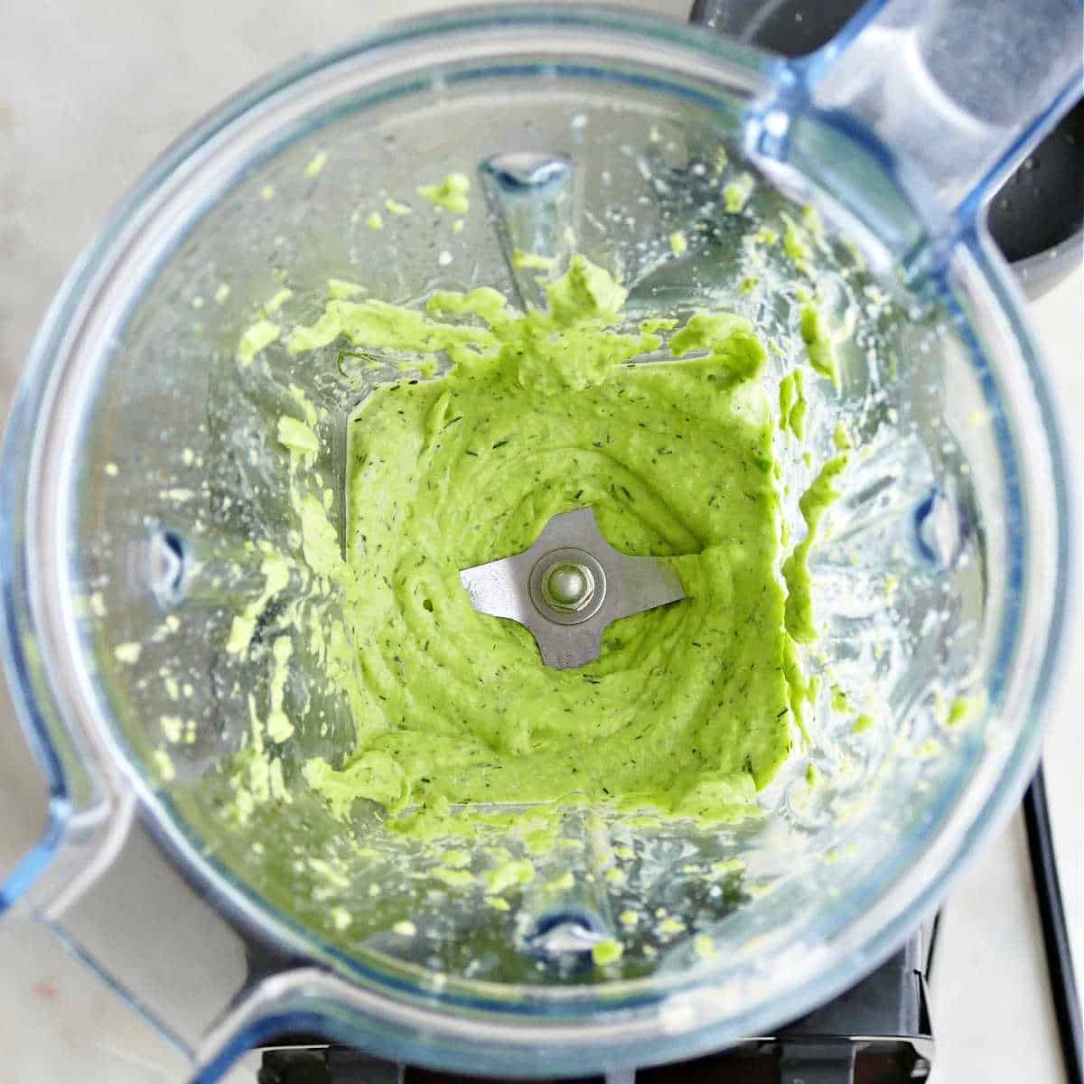 blended fava bean hummus in a blender on a counter