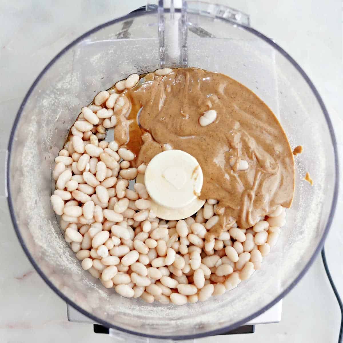 beans, peanut butter, maple syrup, and vanilla before being blended in a food processor