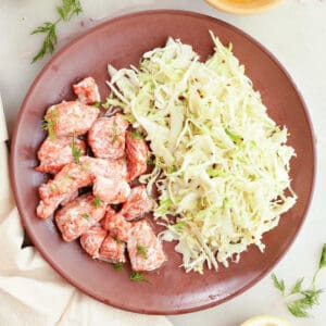 salmon bites and coleslaw on a plate surrounded by ingredients