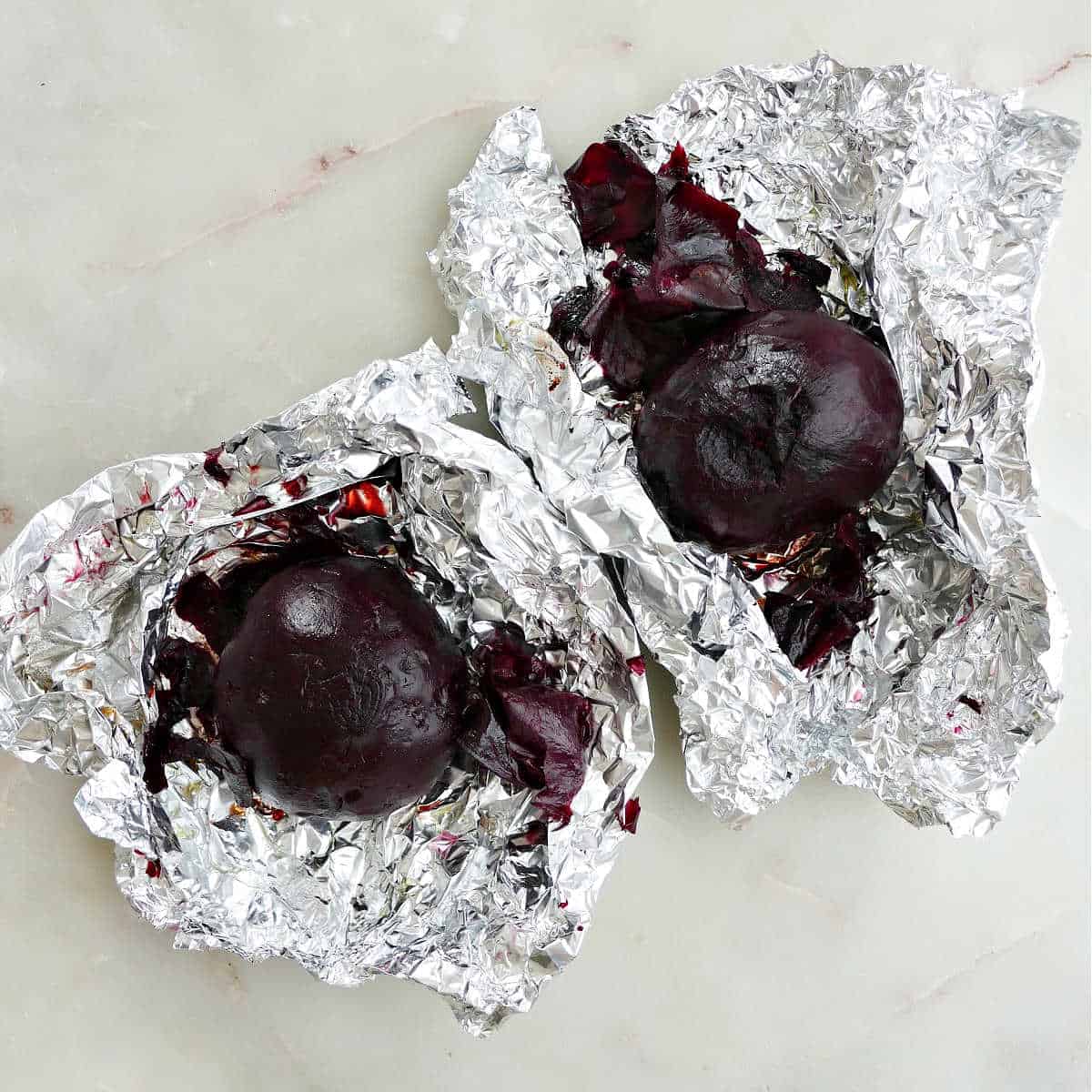 2 roasted beets with the skin removed on top of foil packets