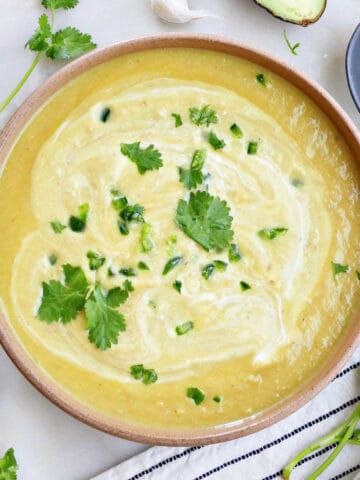 cream of jalapeño soup in a serving bowl topped with cilantro leaves