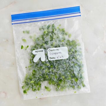 diced jalapeños in a sealed plastic bag with label on a counter