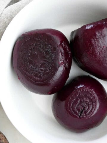 3 beets steamed in the Instant Pot in a bowl on a counter