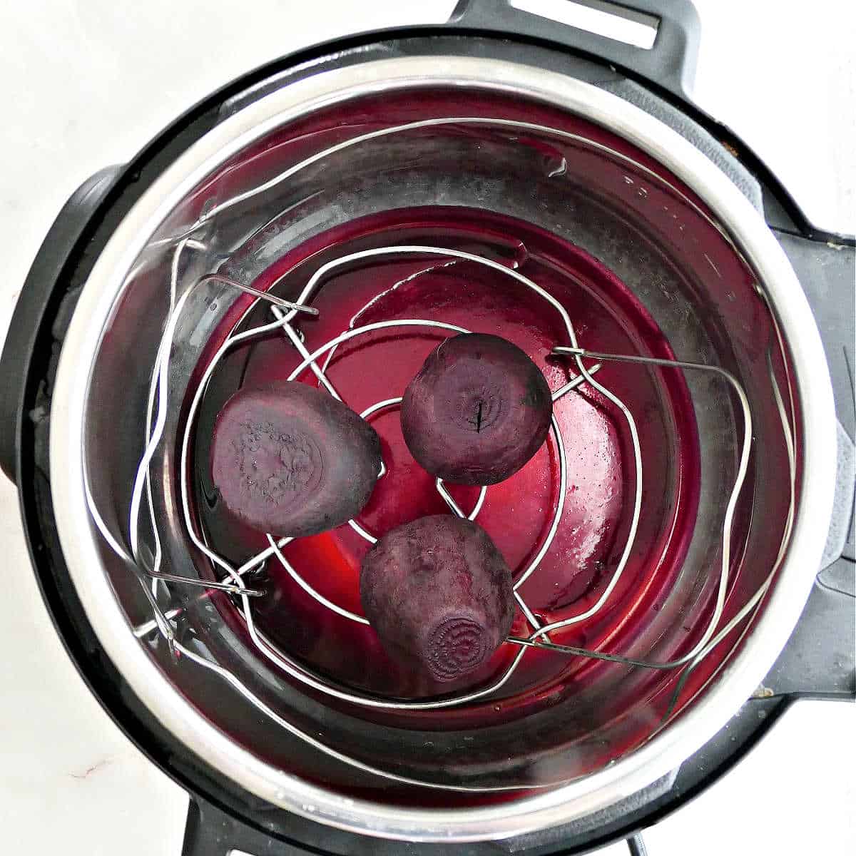 3 red beets in an Instant Pot after being cooked