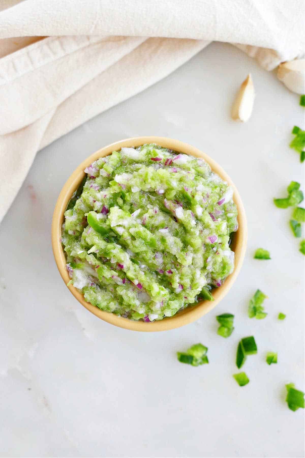 jalapeño relish in a small bowl next to ingredients and a napkin