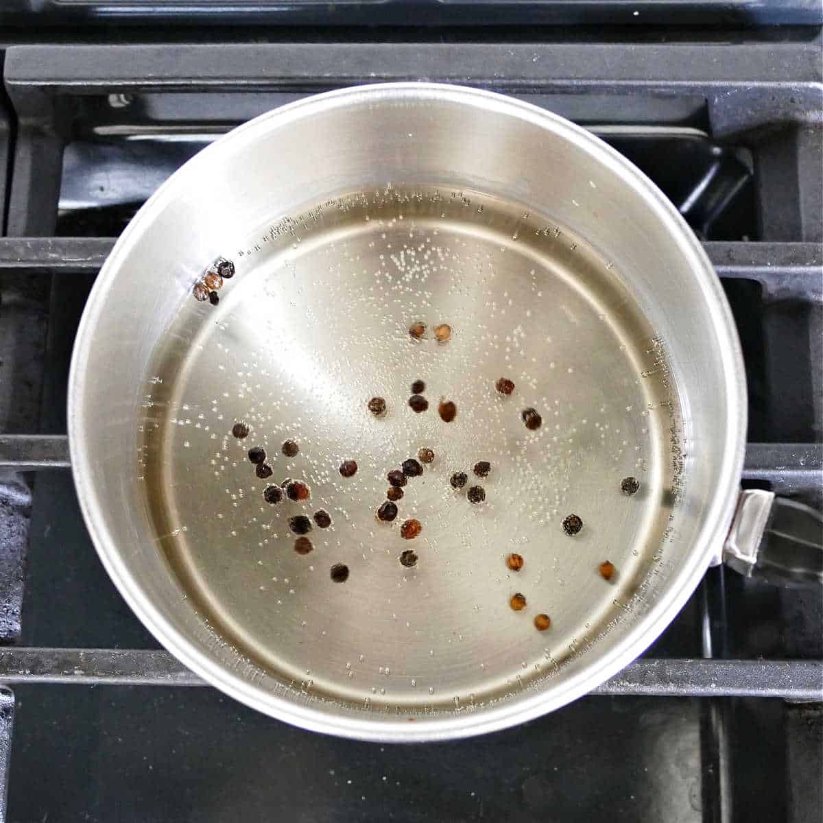 brine for pickled vegetables in a saucepan simmering on a stovetop